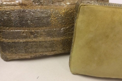 Gold brocade and suede decorative cushions on worktable