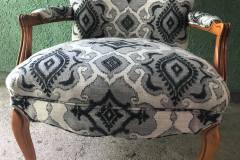 Gray and cream ikat-print French armchair with cabriole legs