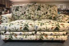 Botanical magnolia-print loveseat in workshop