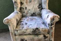 Cream and earth-tone floral wingback chair