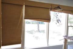 Woven bamboo roman shades installed in client sunroom windows