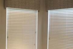 Patterned fabric cornice boards over corner windows in client home