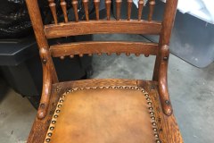 Oak spindle-back dining chair with leather nailhead seat