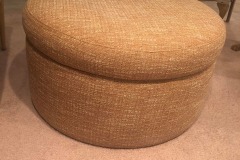 Tan woven round storage ottoman in client living room