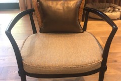 Cane-back accent chair with leather pillow in client home