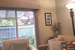Beige textured valance cornice over sliding glass door in living room