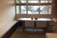 Modern dining nook with built-in banquette and pendant light