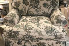 Green and cream floral oversized armchair in workshop