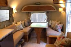 Airstream trailer interior with custom banquette cushions and throw pillows